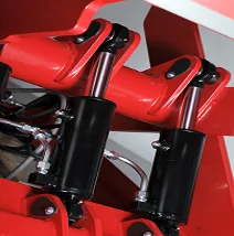 Hydraulic cylinders on red industrial equipment
